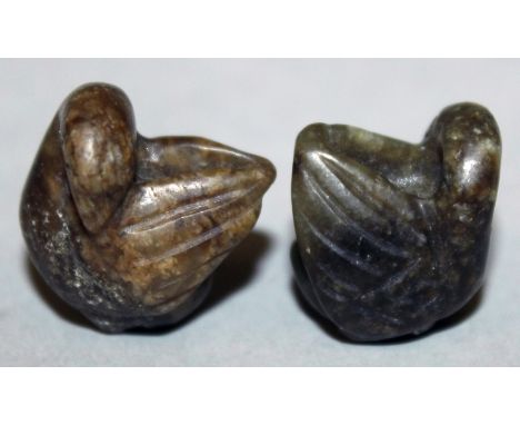 A PAIR OF MINIATURE JADE-LIKE MODELS OF WATER FOWL, each preening its wing, 0.75in high.
