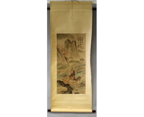 A CHINESE HANGING SCROLL PICTURE ON PAPER, decorated with columns of calligraphy and a seated sage in the company of a deer i