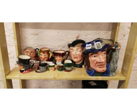 SHELF LOT OF DOULTON CHARACTER JUGS AND BOOK