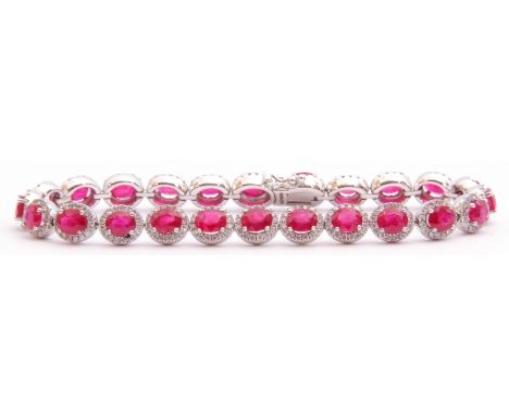 Ruby and diamond set line bracelet featuring 24 oval faceted rubies, each raised within a small diamond surround, rubies tota