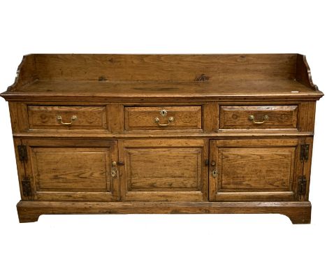 18th century oak dresser base with later tray top pediment, the frieze with three short drawers over two panelled doors enclo