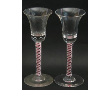 Pair of colour twist wine glasses, the bell bowls above multi series twist stems with Ruby coloured core, (2)