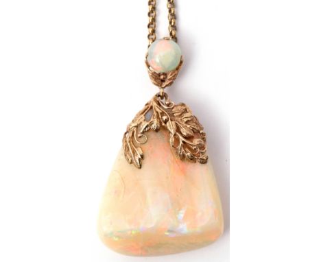 White crystal opal pendant of irregular triangular form, 40 x 35mm, decorated with a yellow metal wire work cap, to a round c