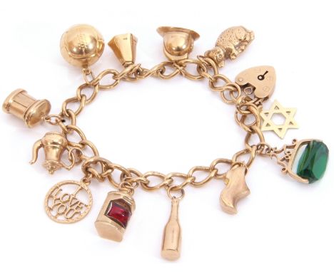 9ct gold curb link bracelet suspending various 9ct gold charms to include a football, a fireman's helmet, lantern etc, 27.5gm