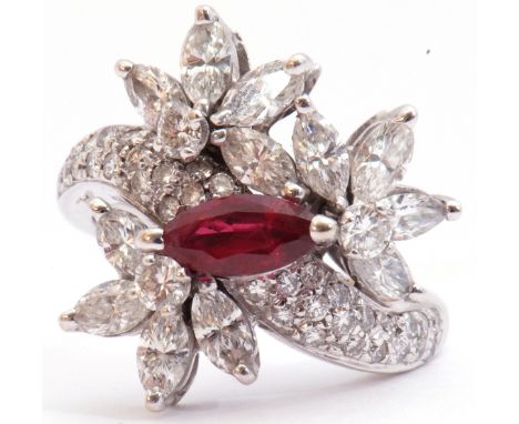 Precious metal, ruby and diamond cluster cocktail ring, centring a marquis shaped ruby raised above a mixed brilliant and mar