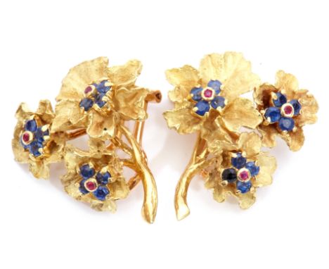 Pair of 18ct gold, sapphire and ruby earrings, a textured design featuring three graduated flower heads, each set with four s