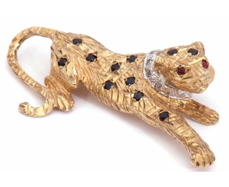 9ct gold, diamond and gem set panther brooch, the heavily textured naturalistic panther decorated with small ruby eyes, a dia