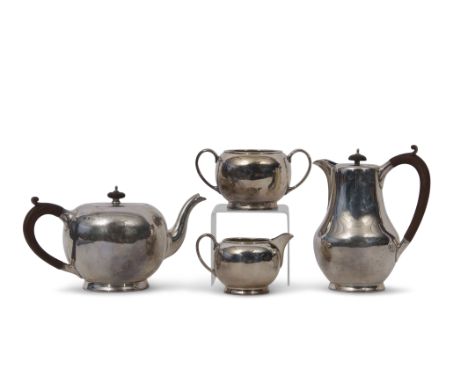 Four piece tea set of circular baluster form comprising tea pot with composition handle and finial, matching hot water jug, t