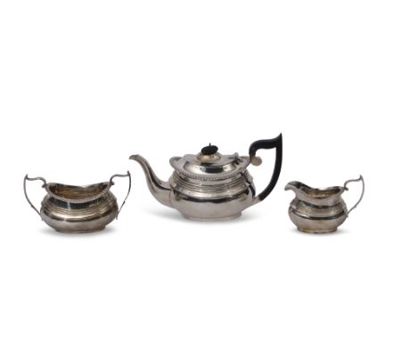 George V three piece tea set of compressed oval form with raised body bands, gadrooned rims, comprising tea pot with ebonised