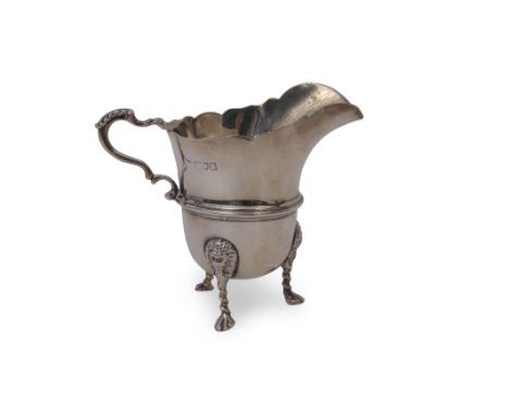 Edward VII large cream jug of helmet shape, having card cut rim, leaf capped scrolled handle and raised body band, supported 