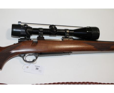 A RUGER .243 RIFLE & HUNTING SCOPE. A lightly used bolt-action .243 rifle No 77228941, with telescopic sight. There is no pro