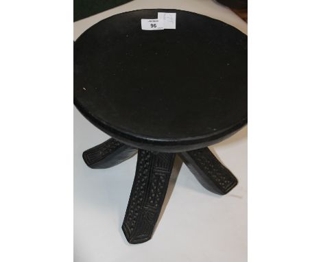 AN AFRICAN STOOL. An Akan tribal stool with three legs and dish top, the original patina has been lost by a later coating. 12