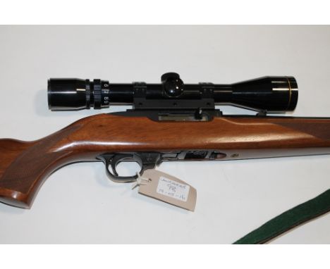 A RUGER .22 RIFLE & MODERATOR. A 10 shot Ruger semi-automatic rifle, fitted with telescopic sight and a moderator. Complete w