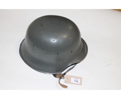 A GERMAN HELMET. A WW11 style German Army helmet, in plain grey with no decals affixed. Complete with a liner and chinstrap, 
