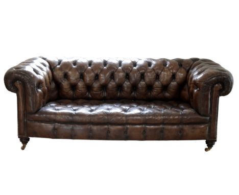 A 19TH CENTURY LEATHER UPHOLSTERED CHESTERFIELD SETTEE with brown leather buttoned upholstery on ceramic castors, Width 208cm