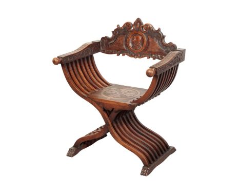 AN ITALIAN SAVONAROLA TYPE FOLDING CHAIR late 19th century, with a portrait roundel carved to the removable back rest, Height