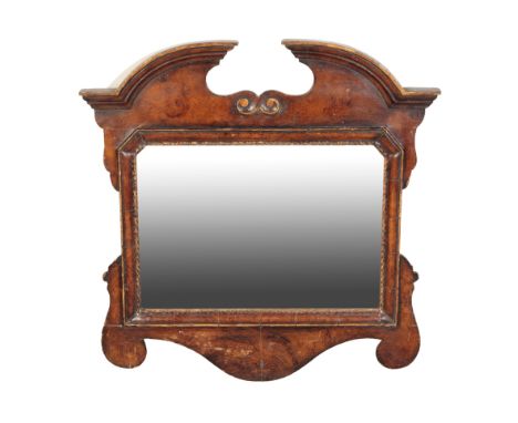 A GEORGE II STYLE GARINED WOOD AND PARCEL GILT MIRROR with broken swan neck pediment and scrolling apron, Height 51cm, Width 