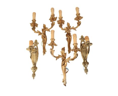 A SET OF THREE GILT METAL TWIN LIGHT WALL APPLIQUES IN LOUIS XV STYLE, second half 20th century, comprising an opposing pair 