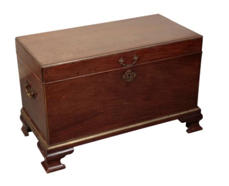 A GEORGE III MAHOGANY CELLARETTE the hinged lid with brass banding to the edges, carrying handles to both sides, a scrolling 