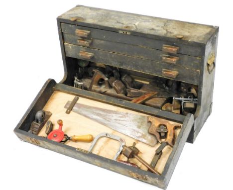 A carpenter's tool chest, with a drop down front opening to reveal three drawers, and contents of moulding planes and other t