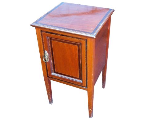 An Edwardian mahogany pot cupboard, with rosewood cross banding and line inlay, the door opening to reveal a single shelf, ra