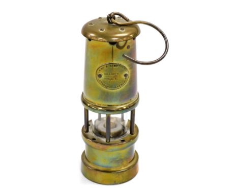 A Hockley Lamp and Limelight Company brass miner's lamp, 17cm high.