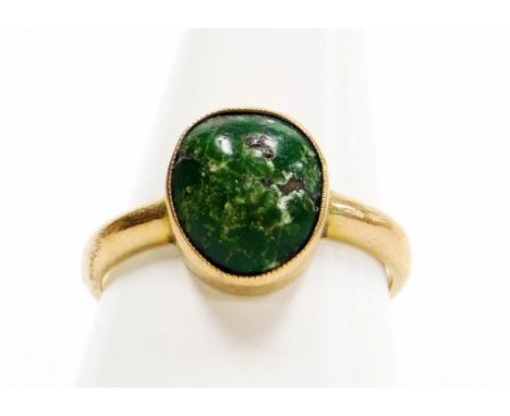 A dress ring, with polished green stone in a rub over setting, on a plain band, yellow metal, stamped 9ct, ring size P½, 3.4g