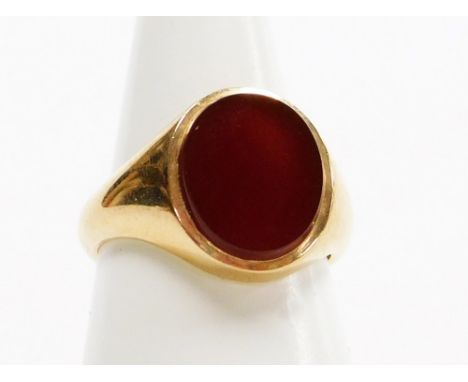 A 9ct gold gentleman's signet ring, with oval crest set with orange agate, London 1956, ring size O½, 7.1g all in, boxed.