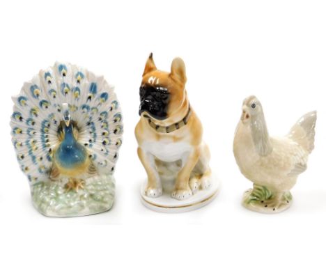 Three ceramic figures, comprising a Valencian porcelain peacock 20cm high, a hen 16cm high, and a Lomonosov porcelain figure 