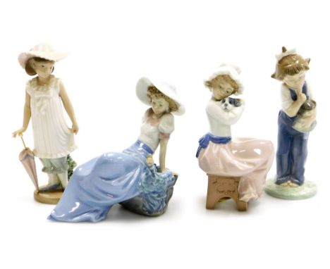 Four Nao porcelain figures, comprising girl with umbrella, 19cm high, girl reposing on rock, 15cm high, girl with doll, 18cm 