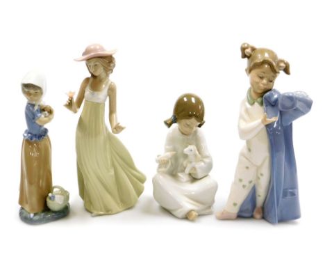 Four Nao porcelain figures, comprising girl feeding lamb, 17cm high, girl holding puppy, 22cm high, girl putting on overcoat,