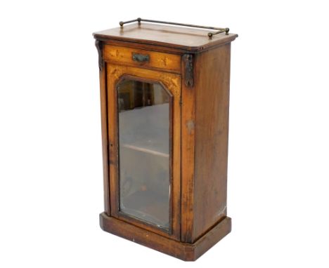 A Victorian walnut and inlaid cabinet, inlaid with vases and scrolling leaves, having a single drawer above a glazed door enc