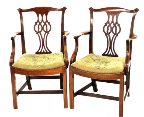 A pair of Chippendale style mahogany carver chairs, with scrolling crest rail, pierced and carved vase shaped splat, floral u