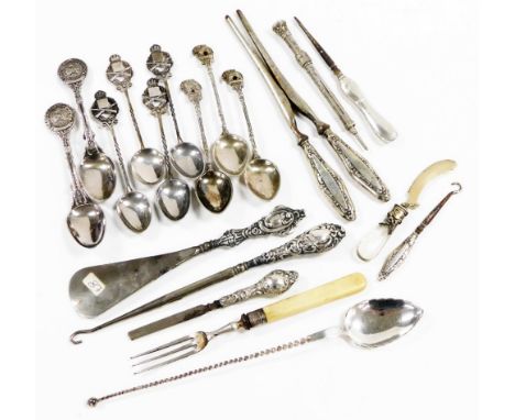 A group of white metal and silver mounted items, to include a shoe horn, white metal tea spoons with shaped elephant handle, 