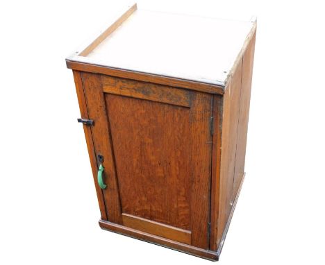 An early 20thC oak cupboard, with a single door opening to reveal a shelf with drawer under, raised on a plinth base, 82.5cm 