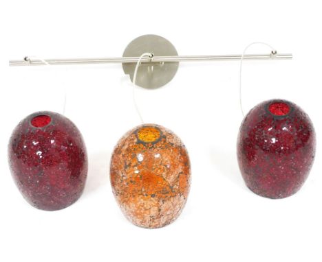 A three branch ceiling light, with crackled red and orange glass pendant shades, 72cm wide. 