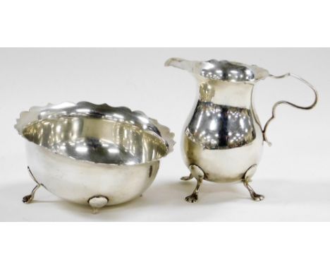 An Edward VII silver cream jug, with a shaped ring and handle, raised on four paw feet, Birmingham 1902, 3½oz, 8.5cm high, an