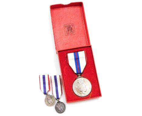 A Queen Elizabeth Silver Jubilee Medal 1977, and two miniature medals. (3)