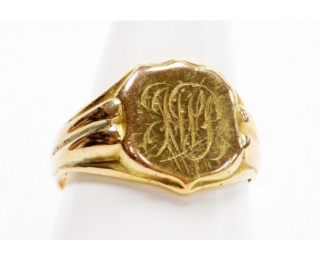A signet ring, with shaped shield crest bearing initials, but rubbed, on reeded shoulders, yellow metal stamped 18ct, size L,