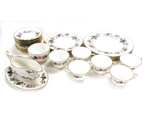 A Royal Worcester porcelain part dinner and tea service decorated in the June Garland pattern, comprising sauce boat on stand