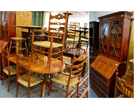 A reproduction yew wood glazed bureau bookcase together with, a similar pedestal dining table, six rope work ladder back dini