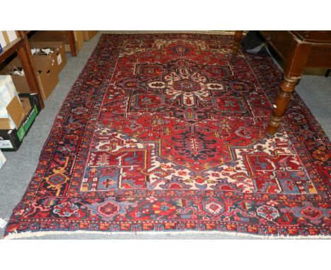 Heriz Carpet, Iranian Azerbaijan, the raspberry field of angular vines centred by a typical medallion