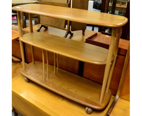 A 1960's/70's Ercol elm three tier tea trolley, labelled, 92cm by 32cm, 70.5cm high 