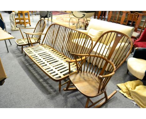 An Ercol elm settee together with a matching low chair and an Ercol rocking chair 