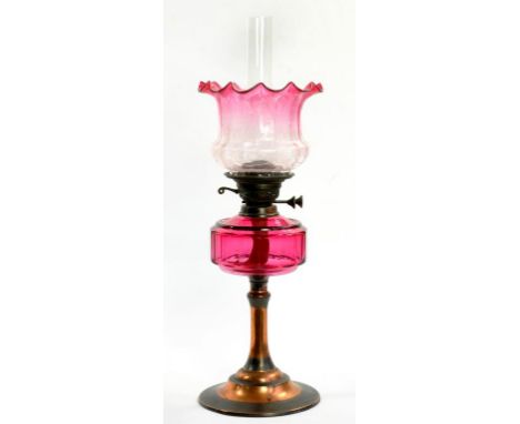 AN EDWARDIAN ART METAL OIL LAMP WITH MATCHING BURNER, CRANBERRY GLASS FOUNT AND ETCHED CRANBERRY GLASS SHADE, 50CM H