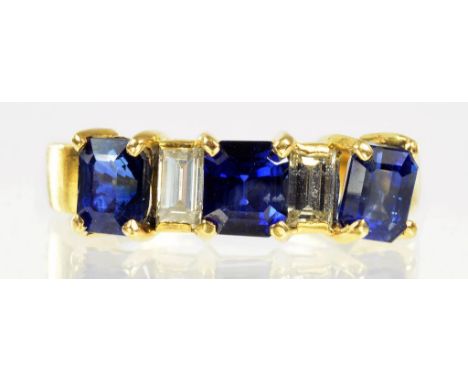 A SAPPHIRE AND DIAMOND RING WITH THREE STEP CUT SAPPHIRES AND TWO BAGUETTTE DIAMONDS, IN GOLD, MARKED 18, SIZE M, 4.2G