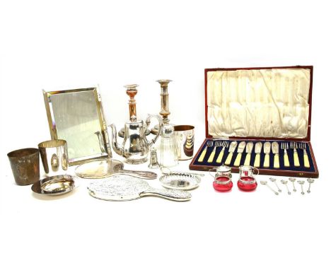 A collection of silver, to include a five piece silver and cranberry glass cruet, a Russian spoon, a napkin ring, two dressin