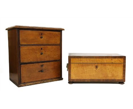 A George III satinwood and rosewood crossbanded tea caddy, the interior fitted twin canisters and glass mixing bowl, 32cm wid