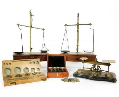 Three sets of brass balance scales, and two sets of boxed weights