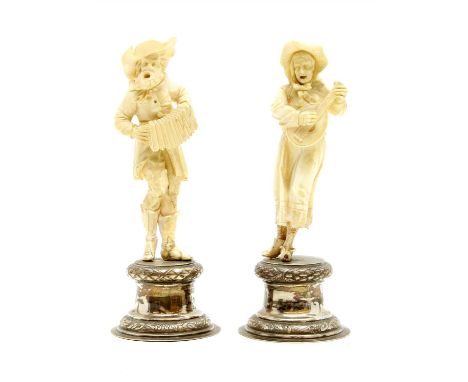 A pair of late 19th century German silver and Ivory figures, in the form of an old lady playing a lute type instrument and an